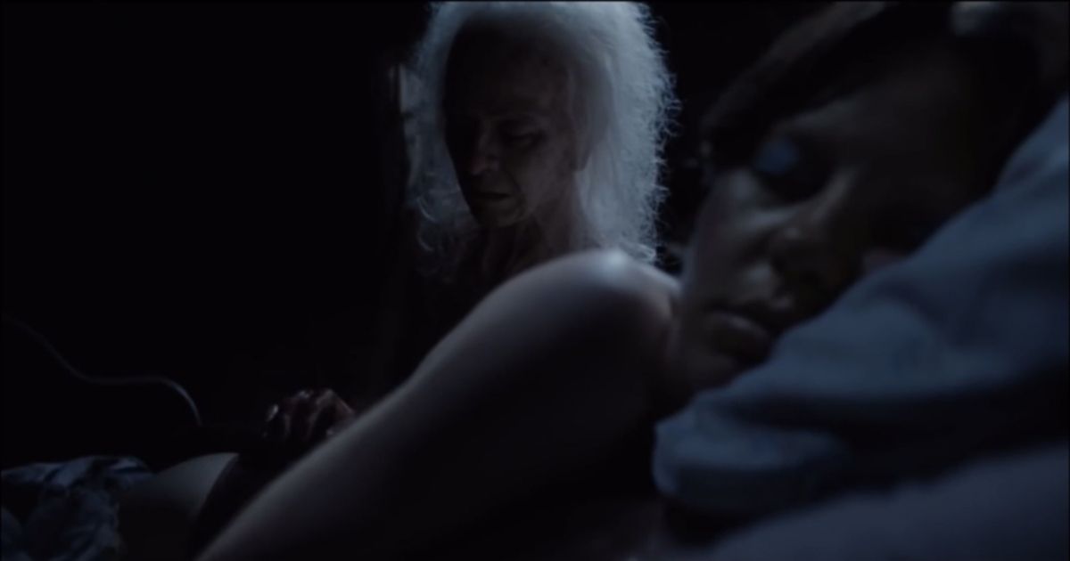The old woman Pearl watches Mia Goth sleep in X