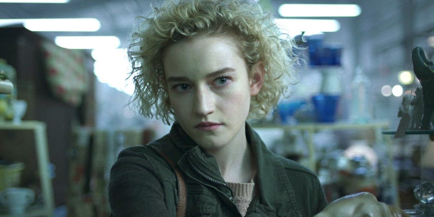 Julia Garner wearing a jacket standing in a store looking off-screen in Ozark