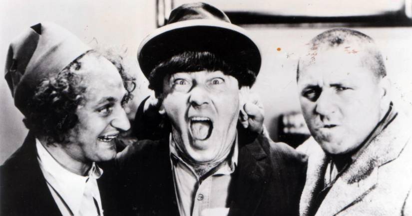 Larry Fine, Moe Howard, and Curly Howard as "The Three Stooges"