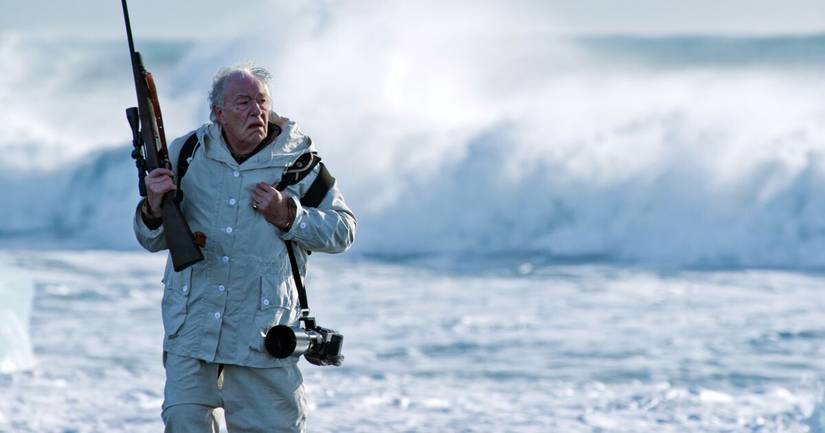 Michael Gambon carries a rifle in Fortitude