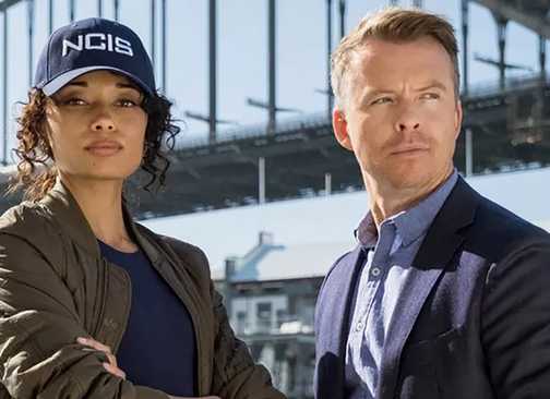 Olivia Swann and Todd Lasance in NCIS: Sydney standing in front of a bridge