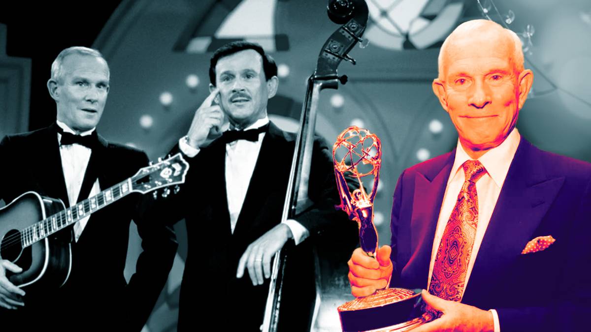 Dick and Tom Smothers wearing tuxedos on stage with a guitar in The Smothers Brothers Comedy Hour and holding up an award