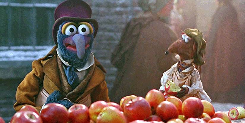 The Muppet Gonzo buying apples dressed in old timely clothes with a top hat in The Muppet Christmas Carol