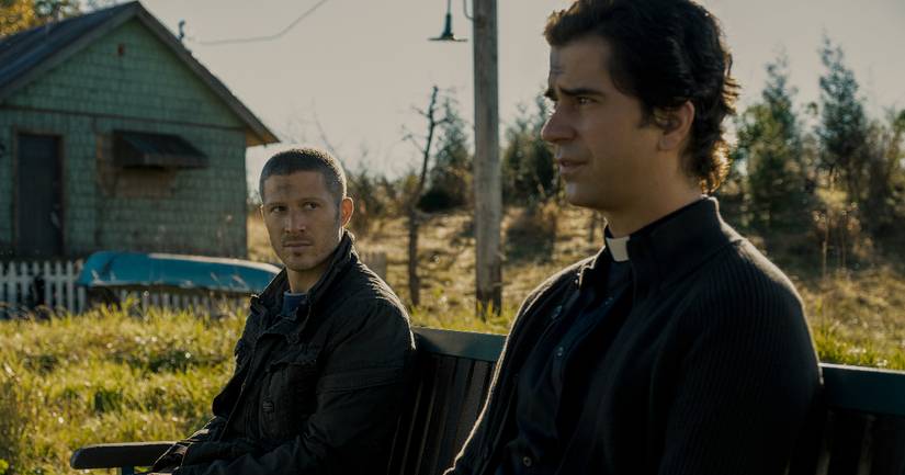 Riley and Paul sit on a bench in Midnight Mass