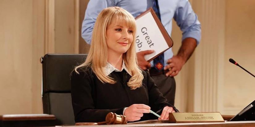Melissa Rauch as Abby Stone sitting in a courtroom as a judge in Night Court season 2