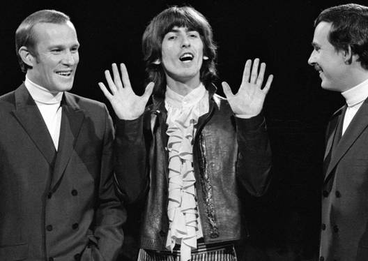 Dick Smothers and Tom Smothers with a guest on stage in The Smothers Brothers Comedy Hour