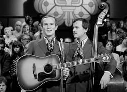 Dick and Tom Smothers playing the guitar on stage in The Smothers Brothers Comedy Hour