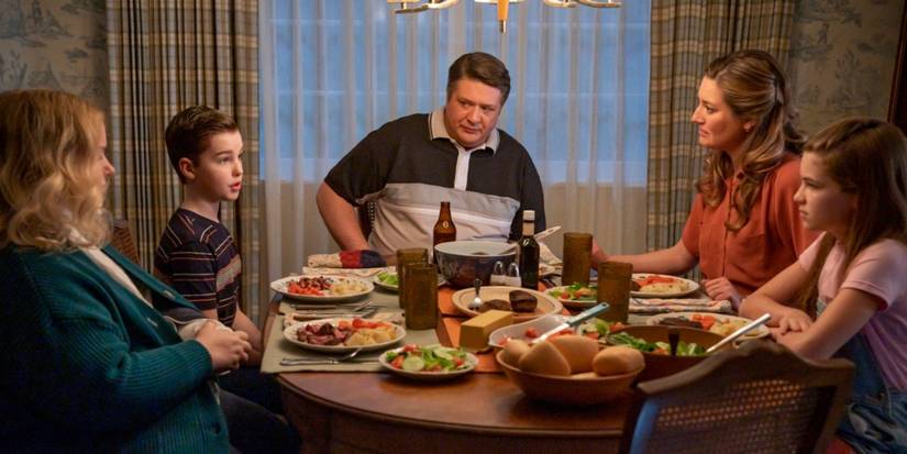 Sheldon, Mary, George, and Missy sit at the dinner table talking in Young Sheldon