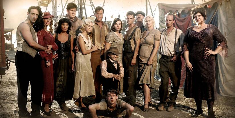 A cast of circus performers pose together