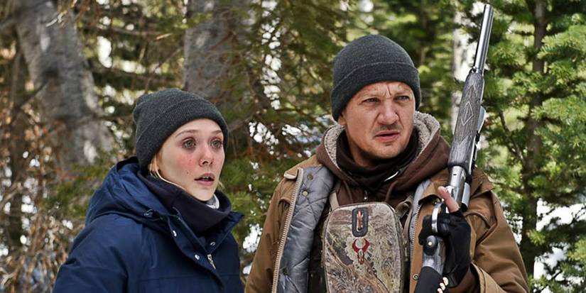 Elizabeth Olsen and Jeremy Renner holding a rifle in Wind River