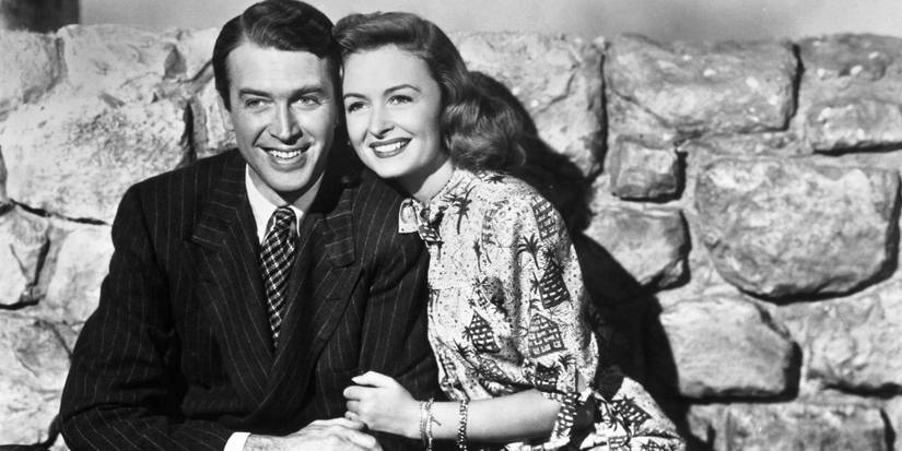 James Stewart and Donna Reed holding each other and smiling in It's a Wonderful Life