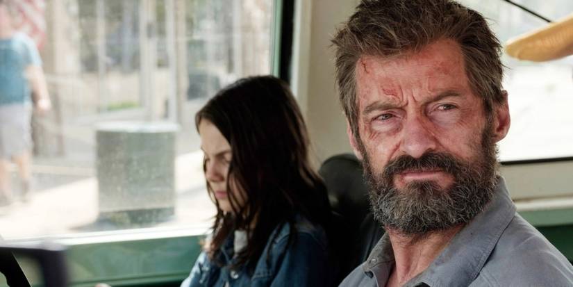 Dafne Keen and Hugh Jackman as X23 and Wolverine, sitting in a pick-up truck in Logan