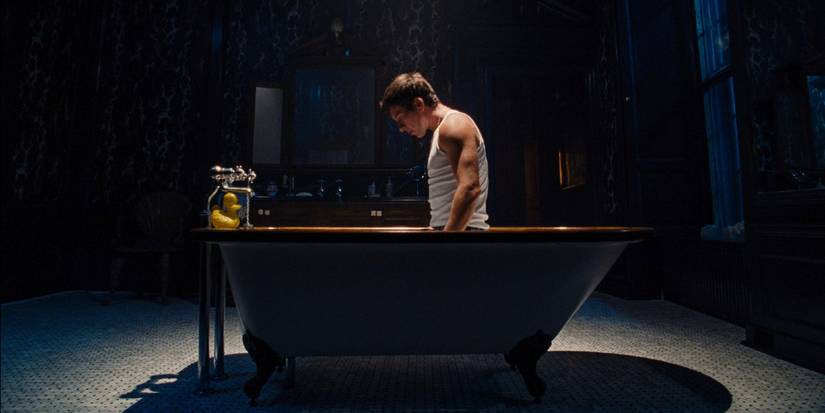 Barry Keoghan as Oliver looking down at a drain in the bathtub in Saltburn