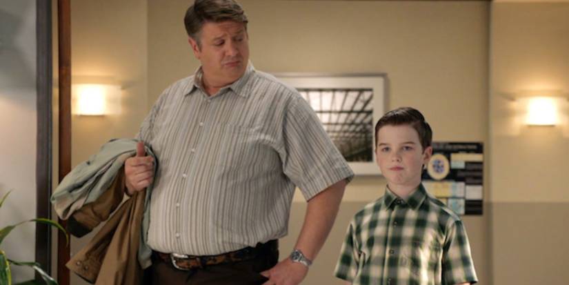 Lance Barber as George Cooper, Sr. and Iain Armitage standing together in Young Sheldon