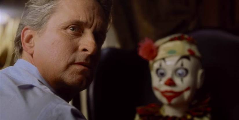 Nicholas Van Orton (Michael Douglas) next to a clown doll in The Game (1997)