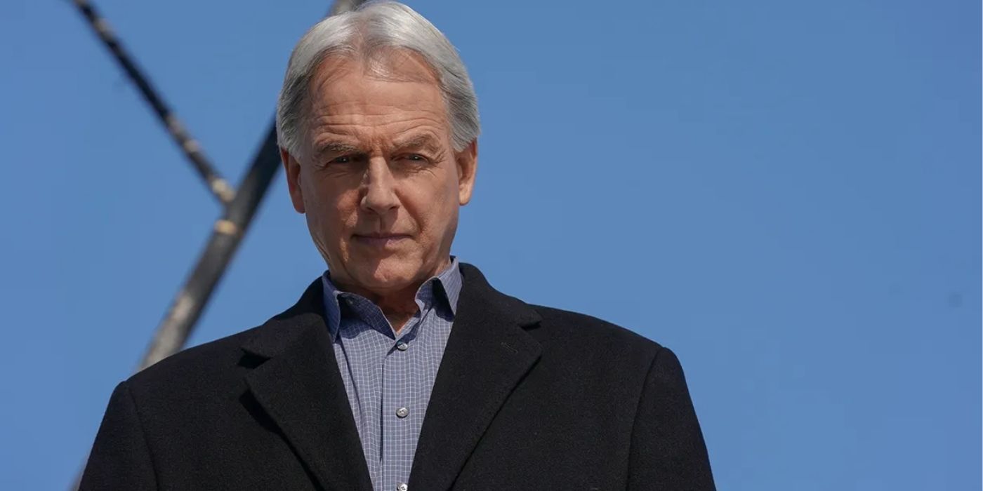 Mark Harmon as Leroy Jethro Gibbs wearing a suit jacket looking down at something off-screen in NCIS