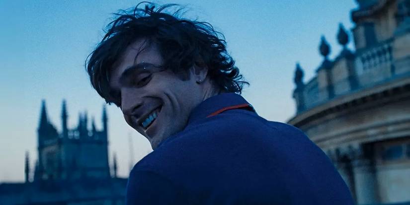 Jacob Elordi as Felix smiling and looking behind him at someone off-screen in Saltburn