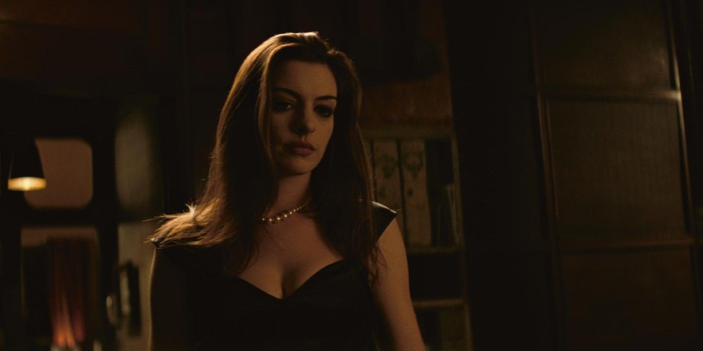 Anne Hathaway admires pearls in The Dark Knight Rises