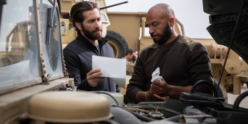Jake Gyllenhaal as John shows Dar Salim as Ahmed a document in Guy Ritchie's The Covenant