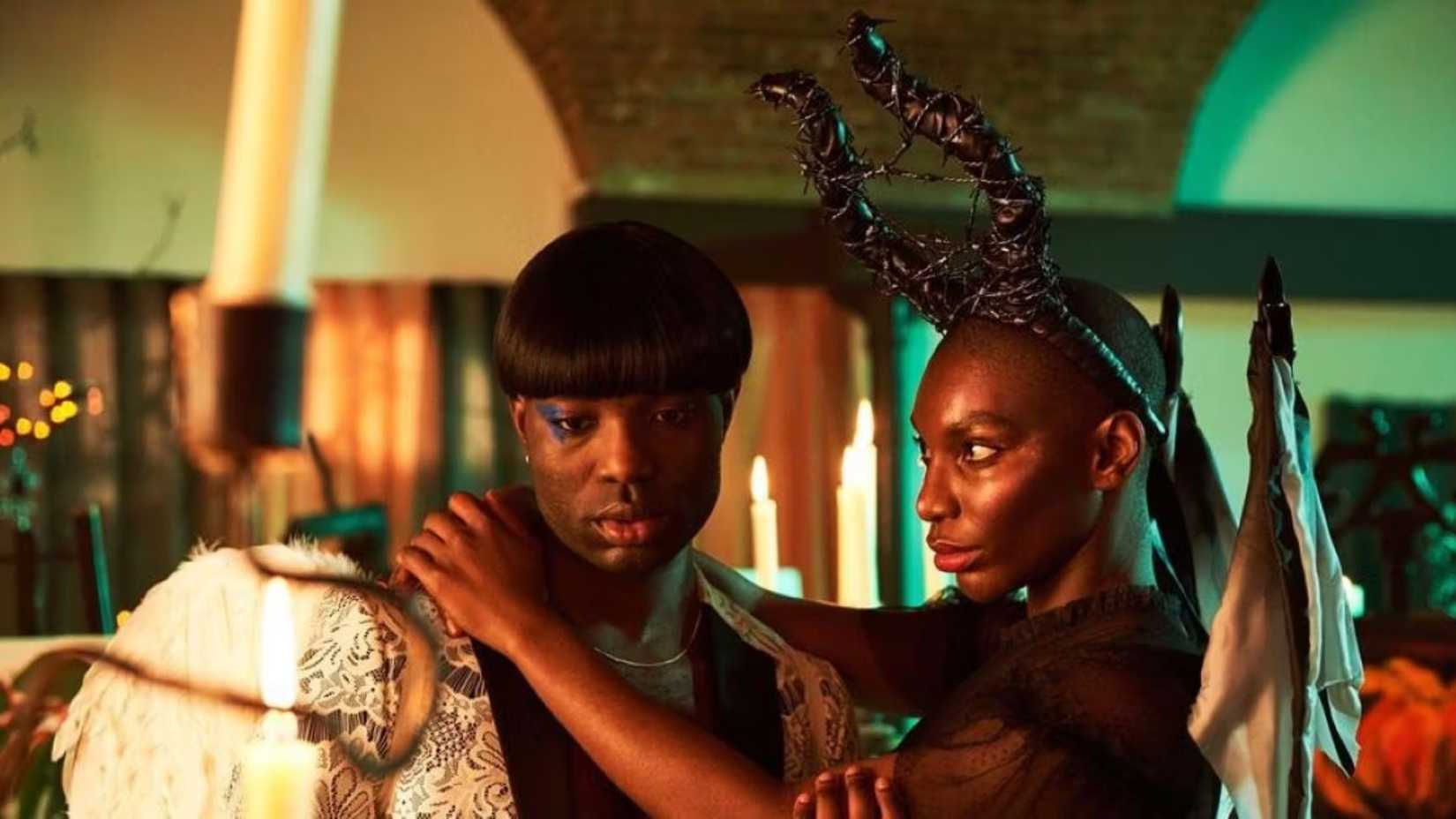 Two people dressed up in costumes for a party wearing horns and wings in I May Destroy You