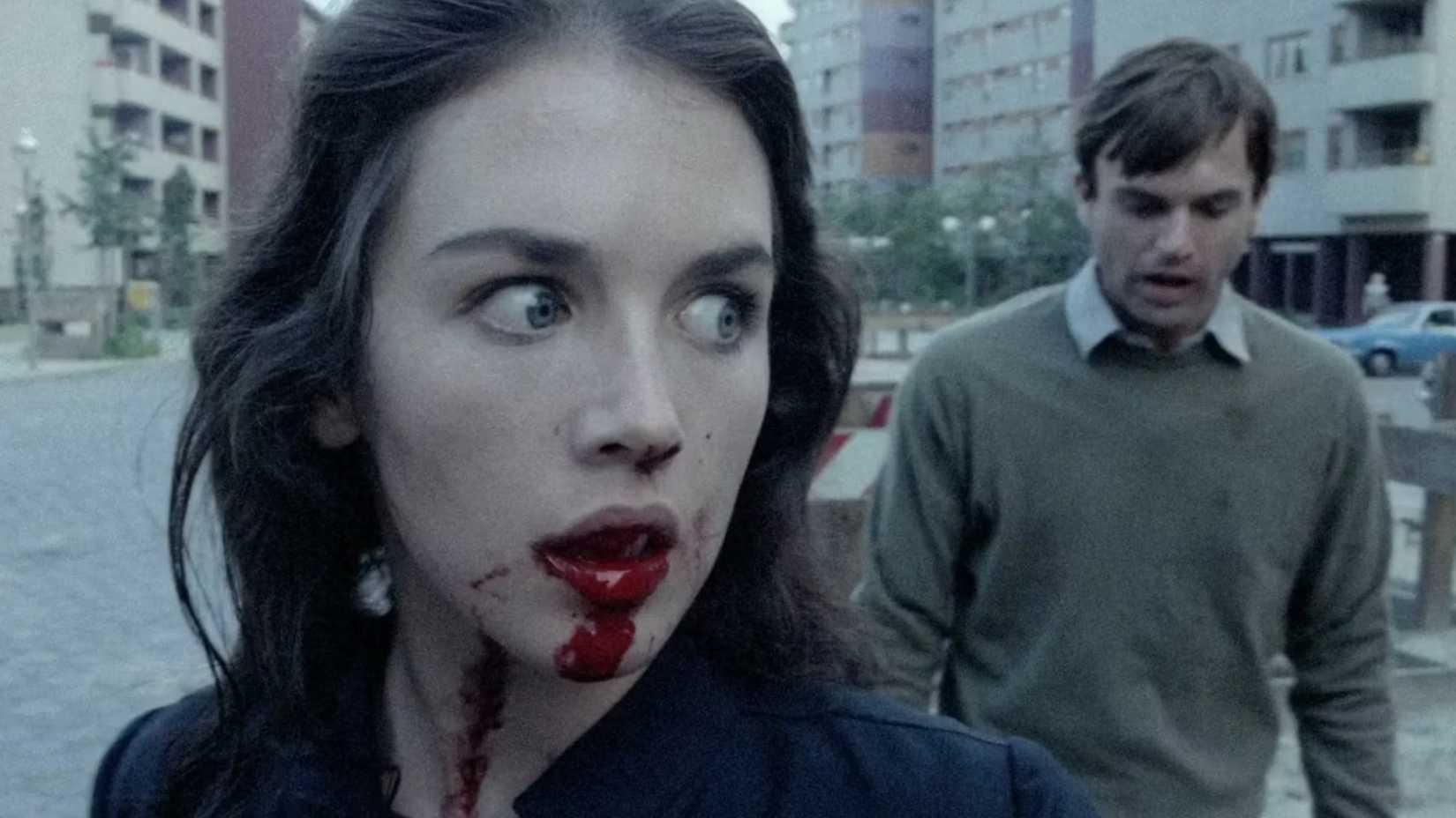 Isabelle Adjani has a bloodied mouth as Sam Neill tries to reach her in a scene from Possession