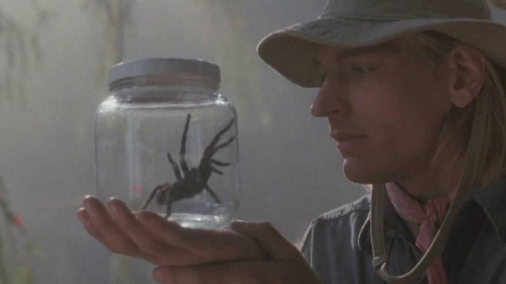 Julian Sands looking at a spider in a jar in Arachnophobia