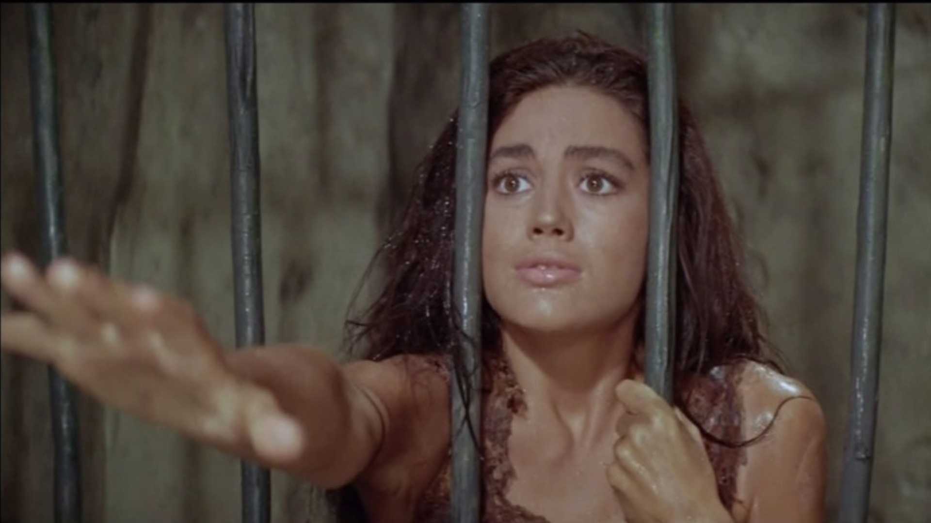 Linda Harrison as Nova reaching through bars in Planet of the Apes