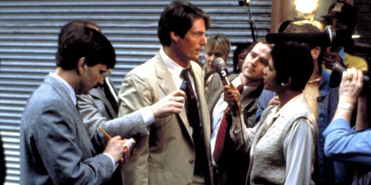 Christopher Reeve in Street Smart wearing a long brown coat with people interviewing him