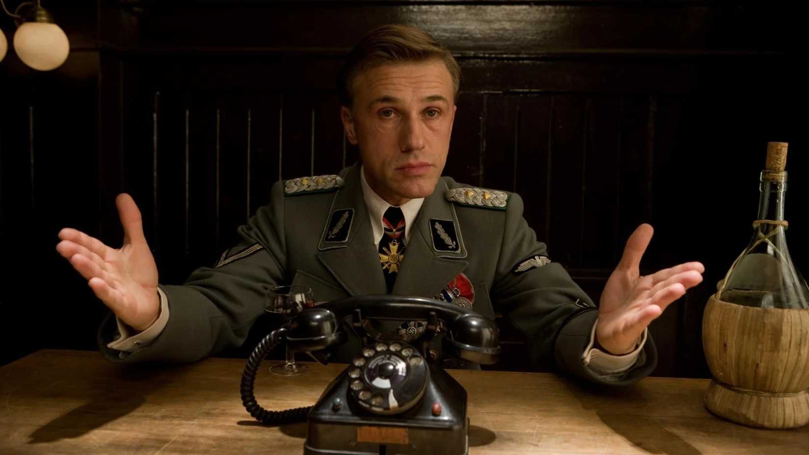 hans landa sits in front of a telephone in the film inglourious basterds
