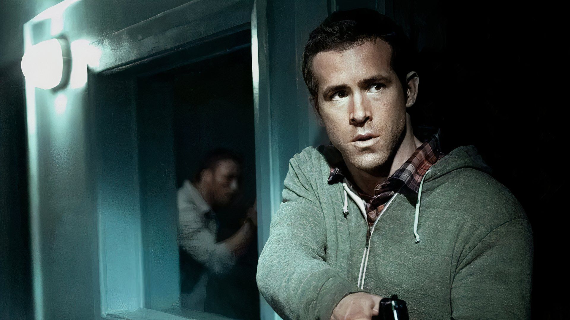 Ryan Reynolds looks concerned in Safe House