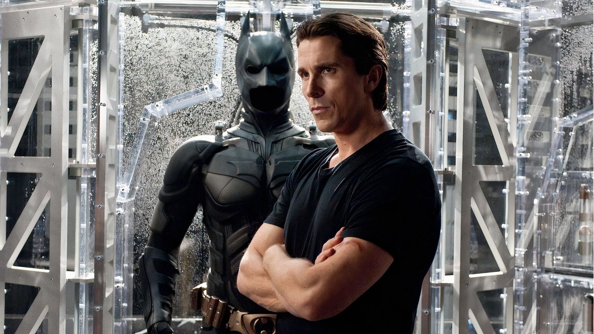 Christian Bale standing next to his Bat suit