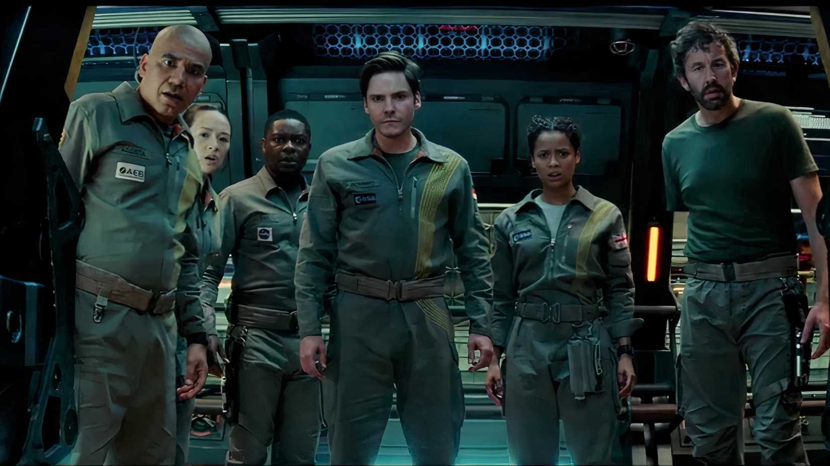 a group of astronauts look at something while looking scared in the film the cloverfield paradox