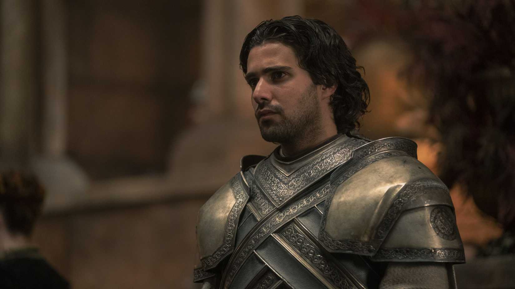 Fabien Frankel as Criston Cole standing tall and staring into the crowd In House Of The Dragon, We Light The Way (1)