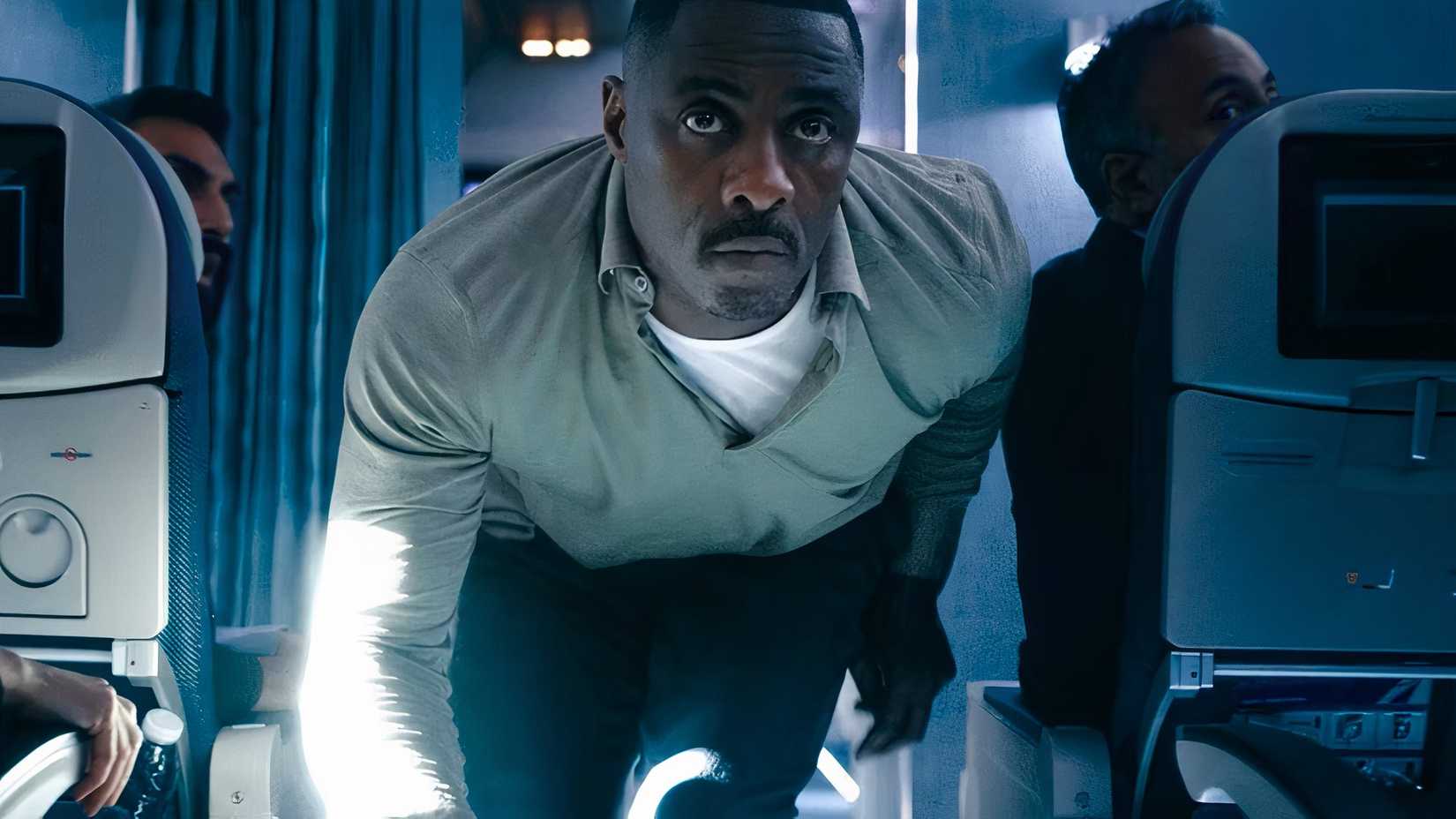 Idris Elba in Hijack crouching on a plane.
