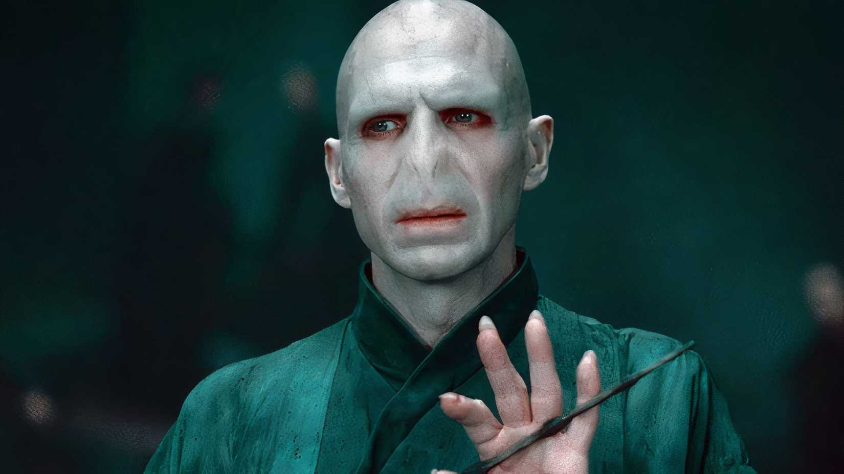 Voldemort holding his wand and looking at something off-screen in Harry Potter