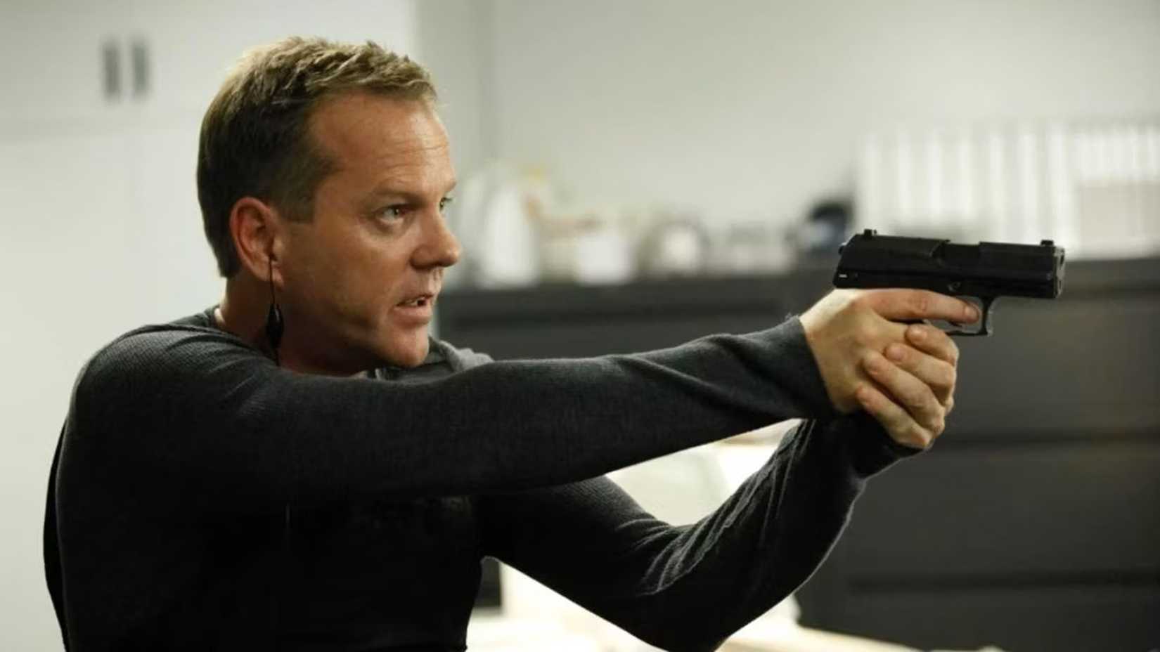 Kiefer Sutherland as Jack Bauer in 24 holding out a gun