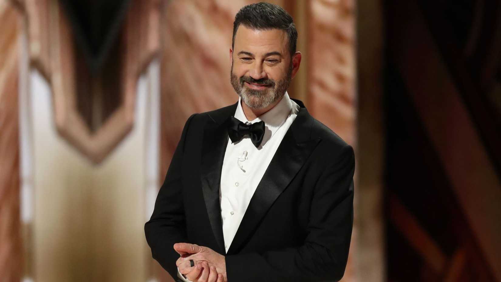 Jimmy Kimmel holding his hands while hosting the Academy Awards