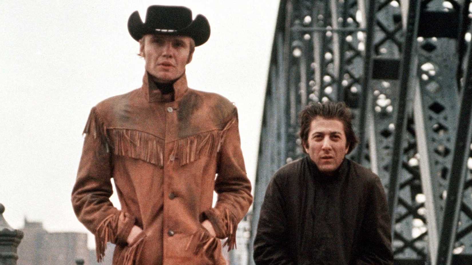 Jon Voight and Dustin Hoffman walk through New York CIty in a scene from Midnight Cowboy