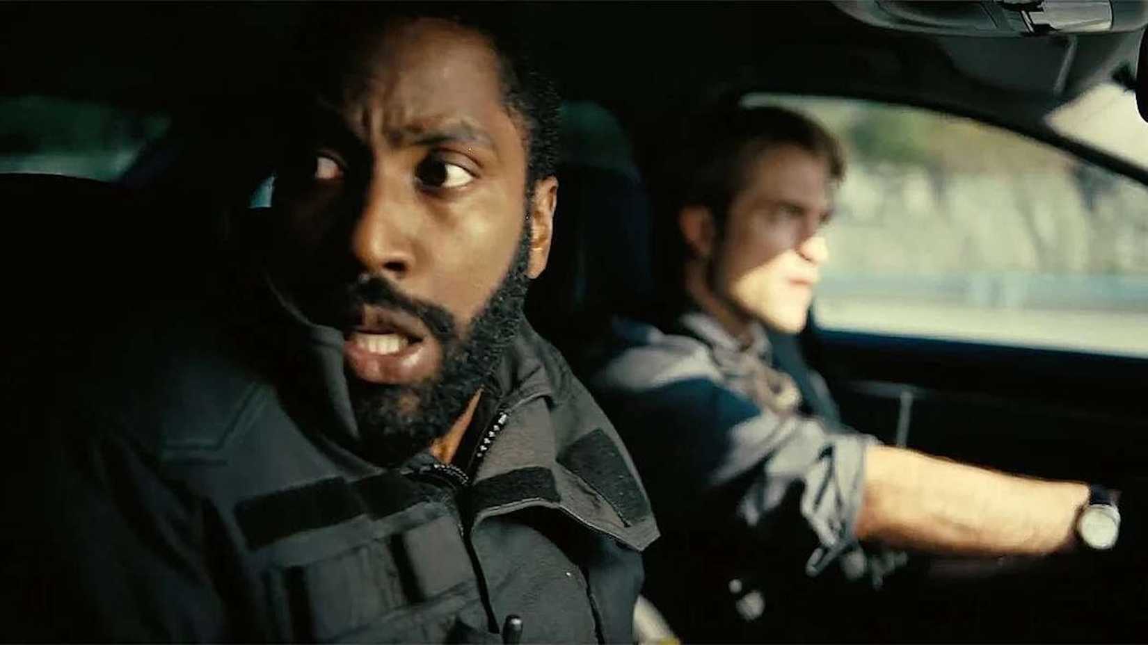 John David Washington and Robert Pattinson driving a car in Tenet