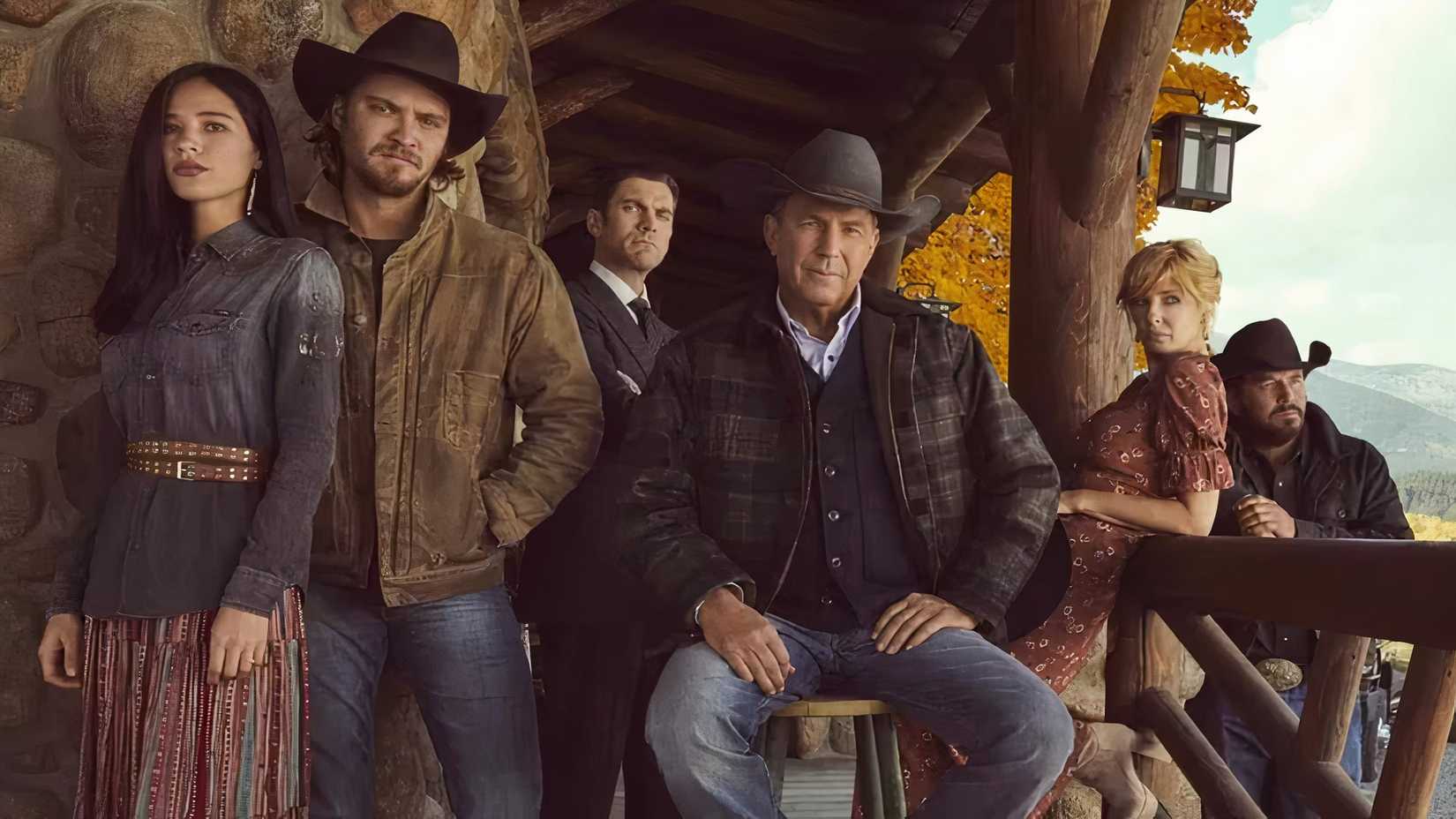 The Yellowstone cast, including Kevin Costner, Luke Grimes Kelly Reilly and Cole Hauser pose on a front porch