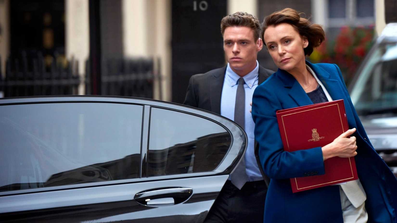 A man escorts a woman to her car in Bodyguard.