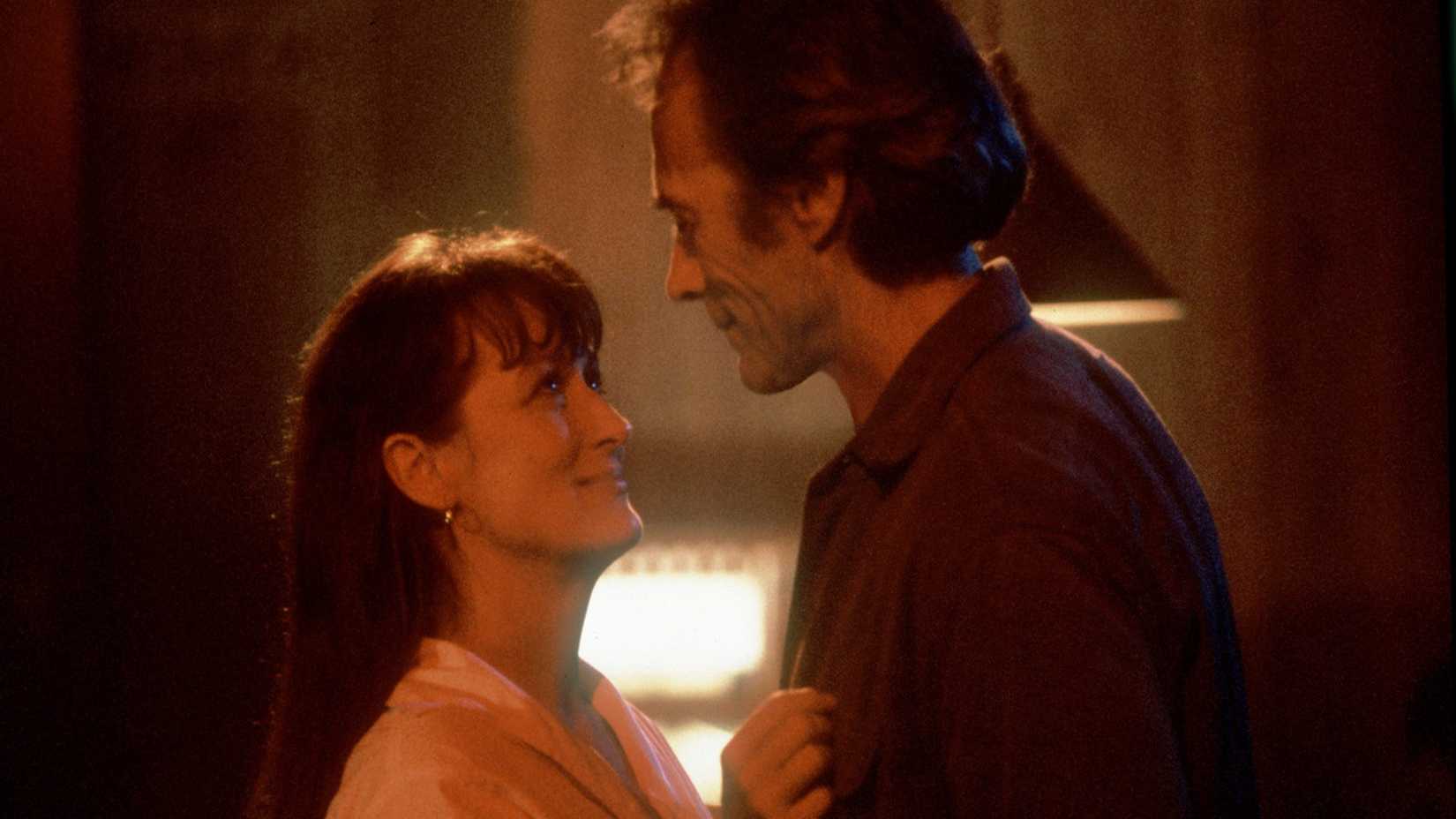 a couple shares a warm embrace in the bridges of madison county