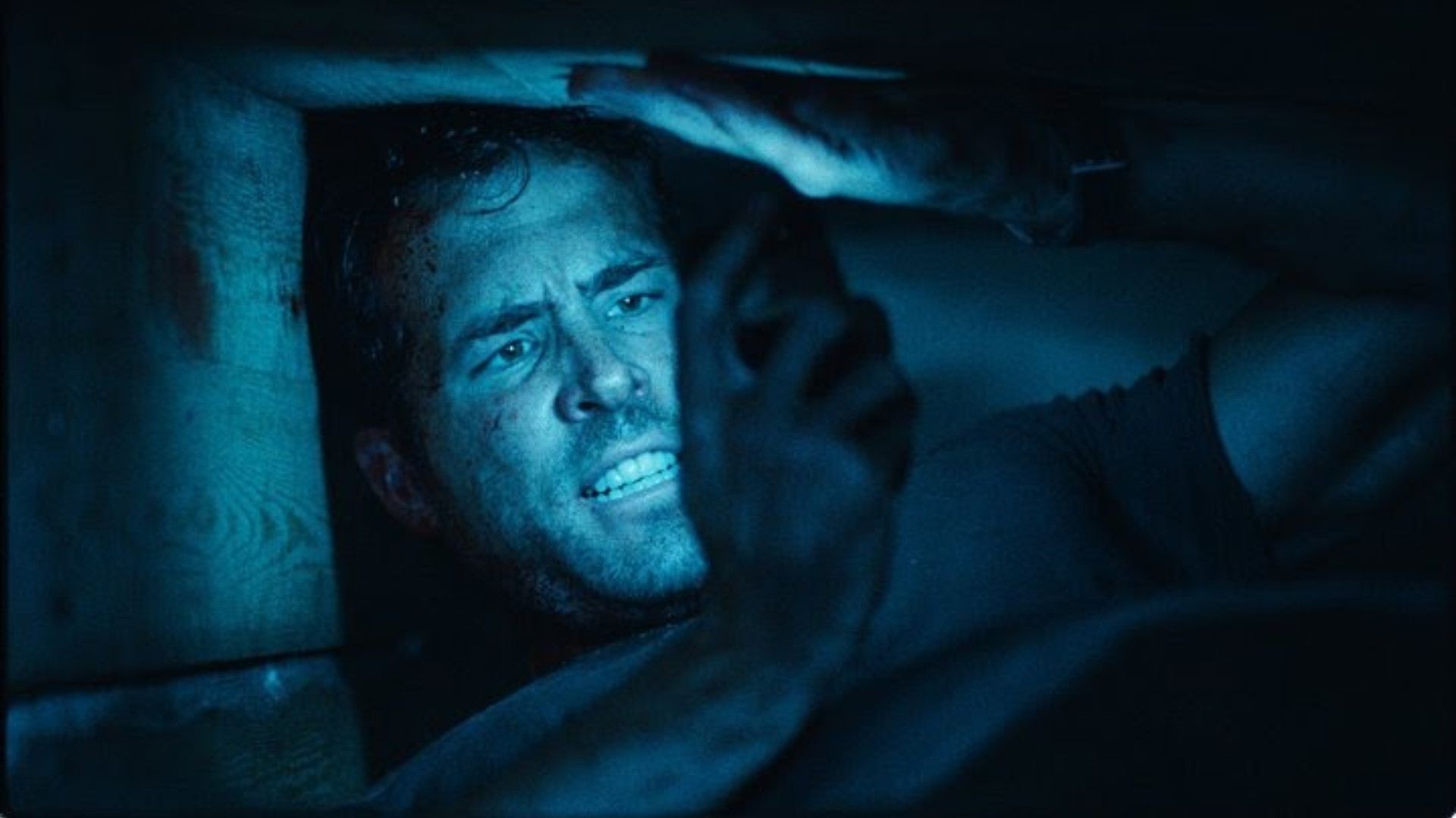 Ryan Reynolds' face is illuminated by BlackBerry phone in Buried