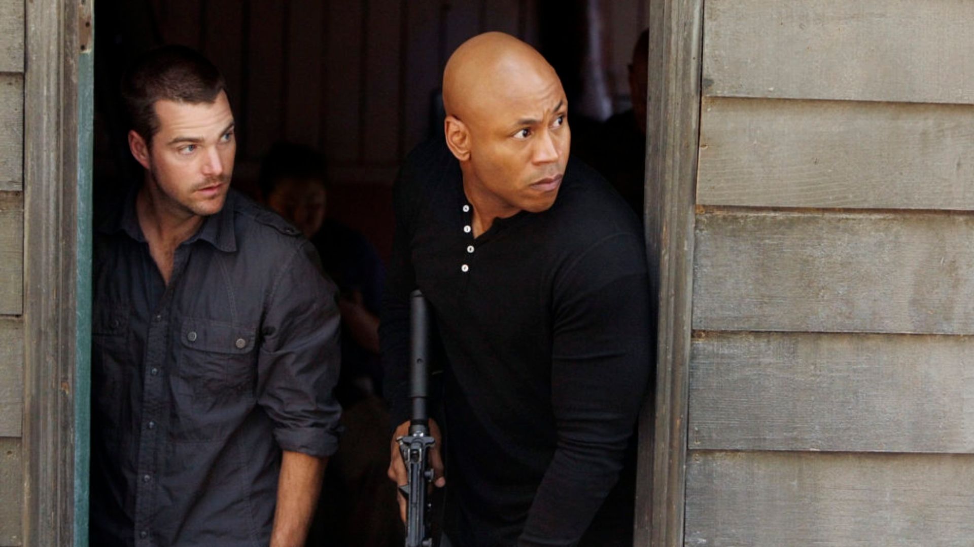 G & Sam in NCIS: Los Angeles holding rifles peering around a corner 