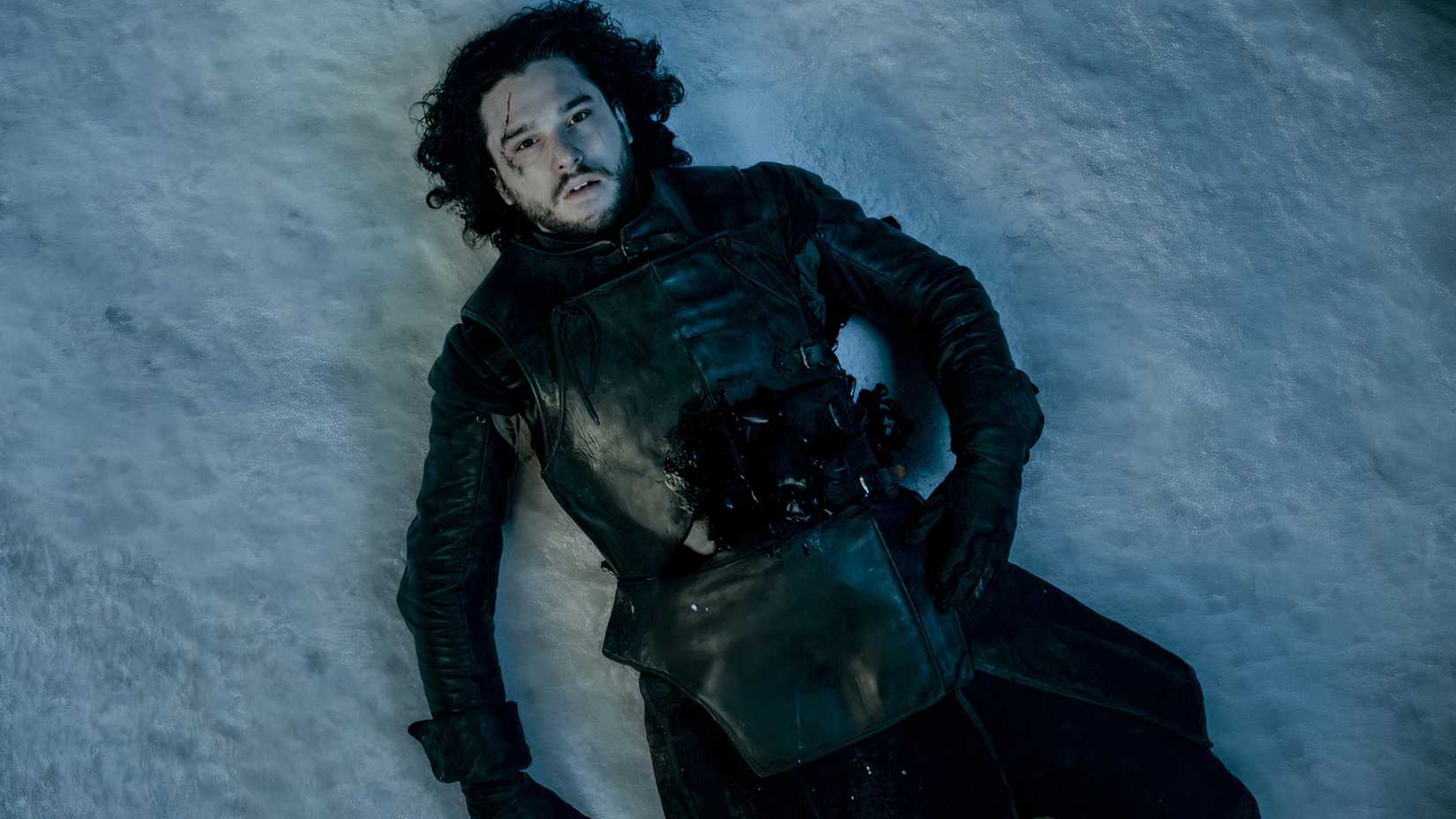 Jon Snow lying dead in the snow on Game of Thrones.