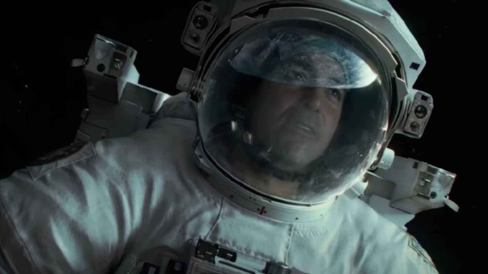 George clooney wears a spacesuit and floats in space in the film gravity