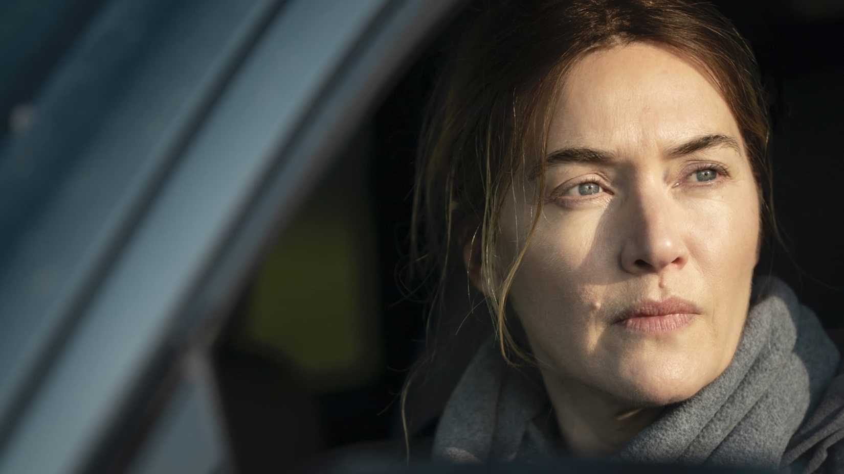 Still from Mare of Easttown with Kate Winslet looking out of a window