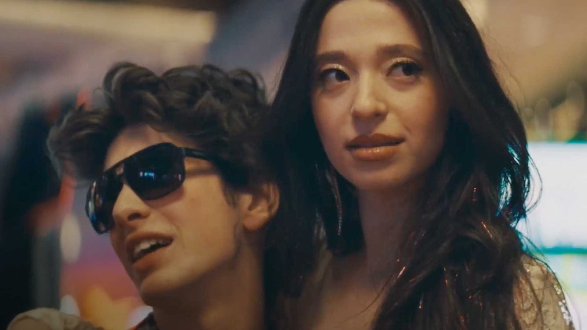 Mikey Madison in Anora smiling and looking off-screen