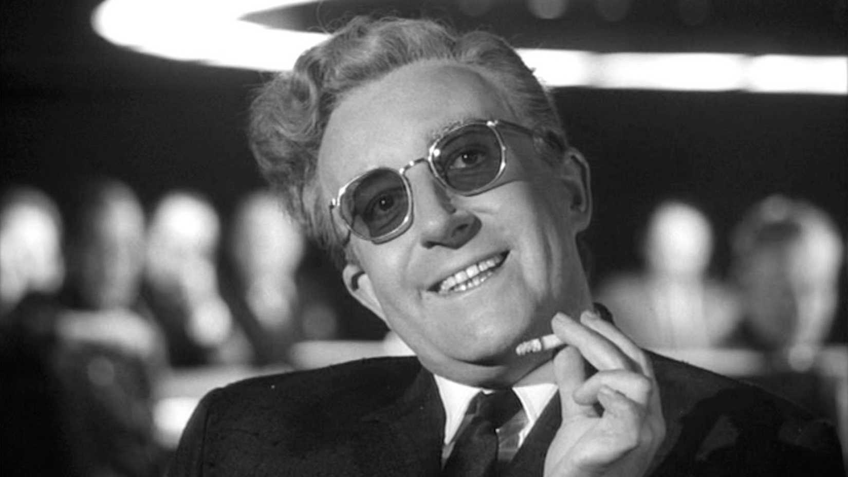 A man smoking a cigarette and smiling in Dr. Strangelove