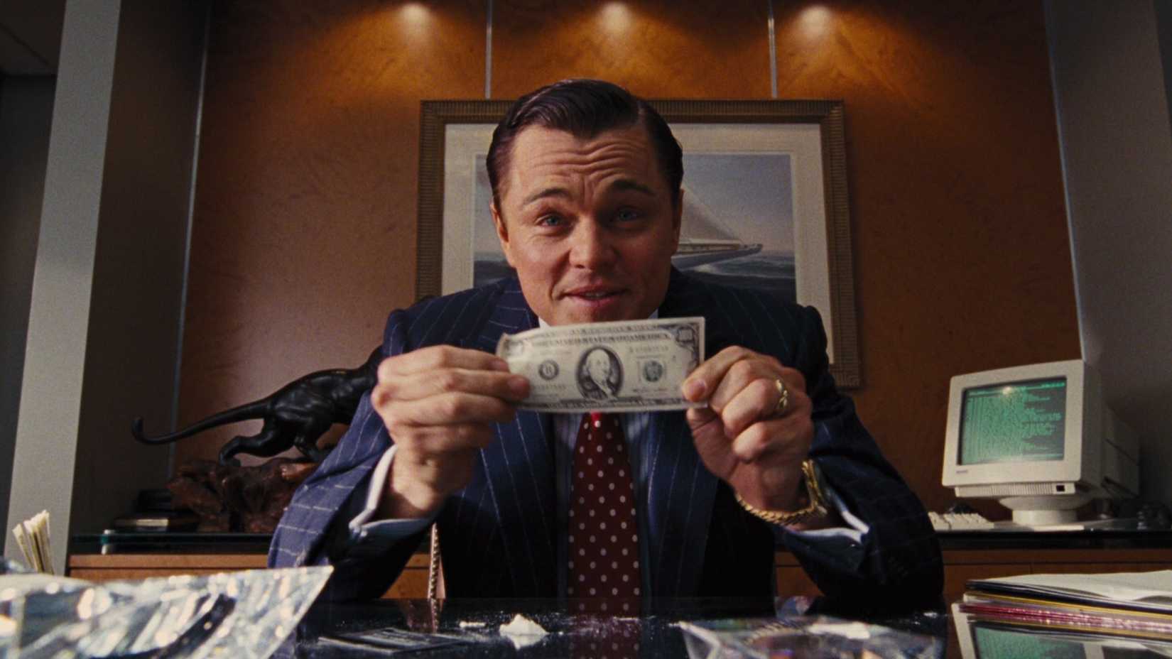 Leonardo DiCaprio holding a 100 dollar bill in The Wolf of Wall Street